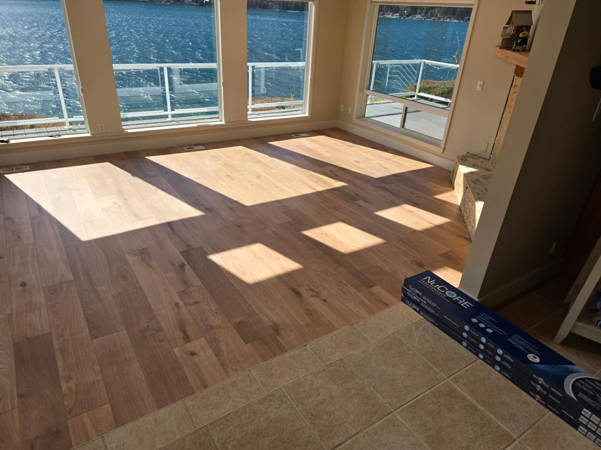 NuCore Performance LVP install in progress with product box on tile transition