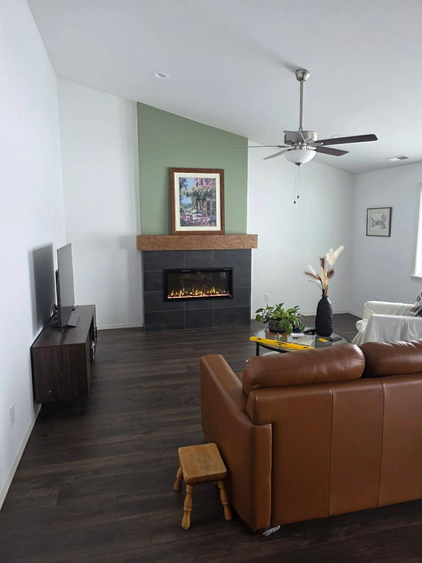 Finished Chelan living room with fireplace feature wall, new flooring, paint, and lighting