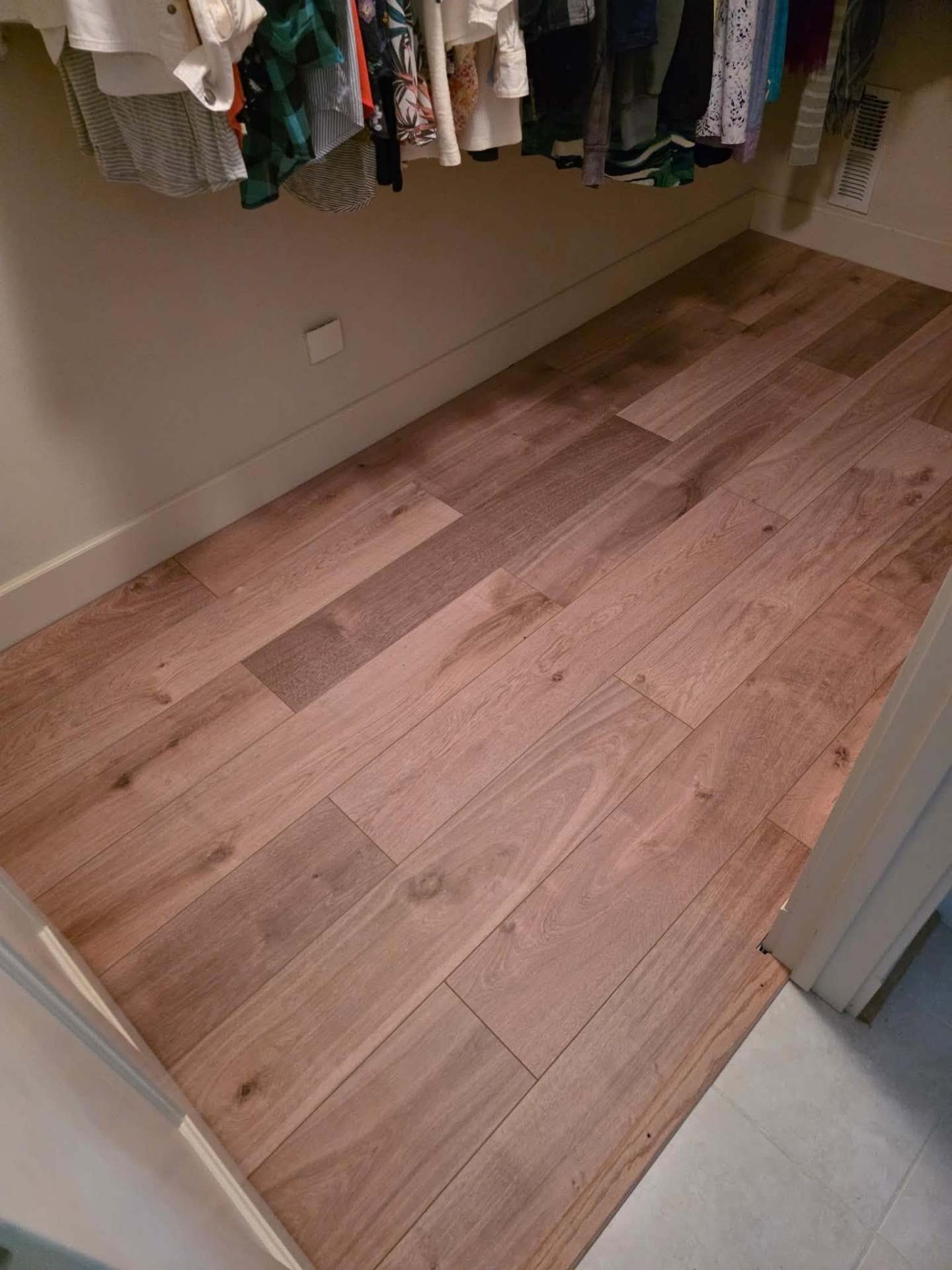 Luxury vinyl plank flooring detail in a walk-in closet in Manson WA