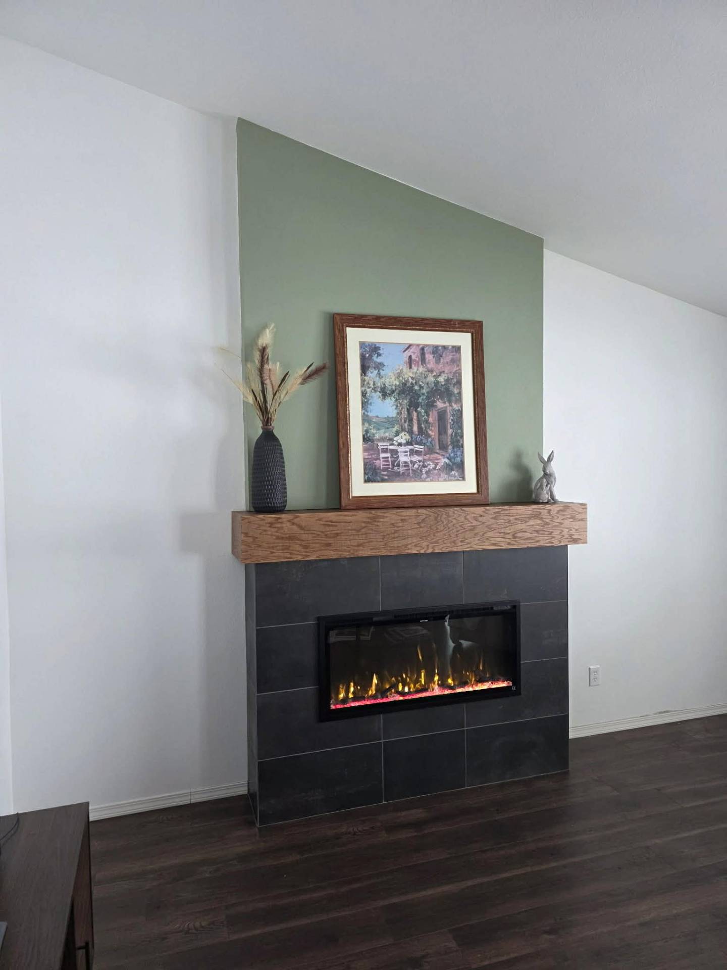 Chelan WA living room fireplace with slate tile, sage accent, and decor on solid wood mantel