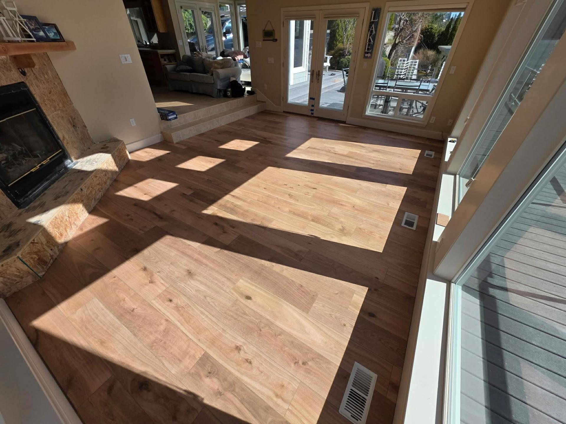 Wide-plank waterproof LVP flooring around stone fireplace hearth in Chelan WA