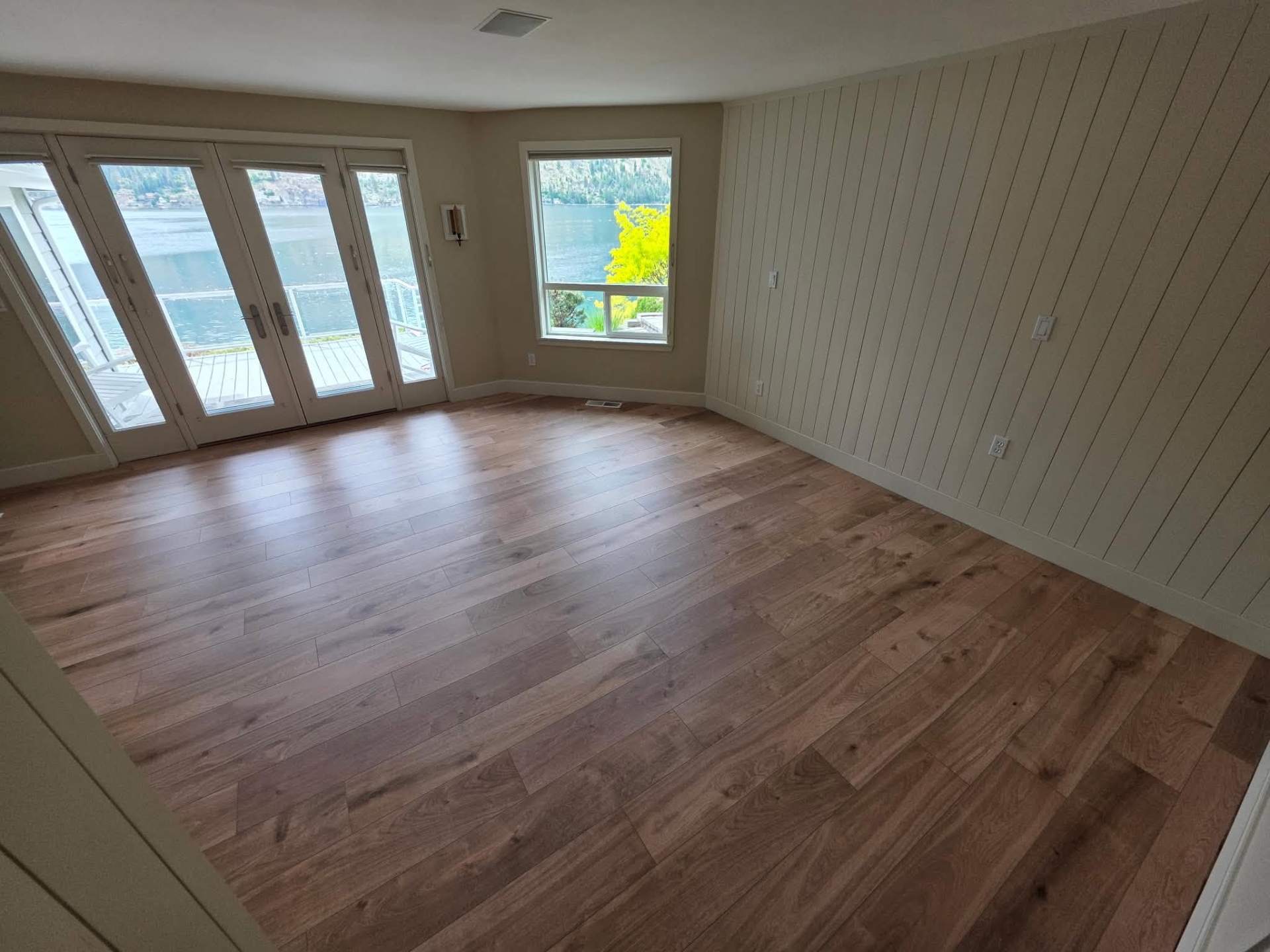 Wide-plank LVP flooring install in a Lake Chelan area home with shiplap accent wall