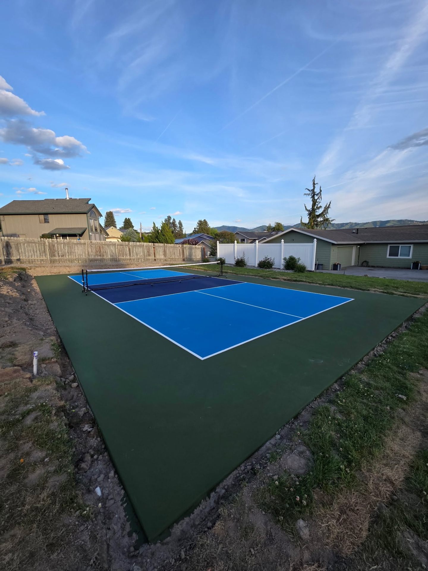 Backyard pickleball court ground-level view with portable net in Chelan WA