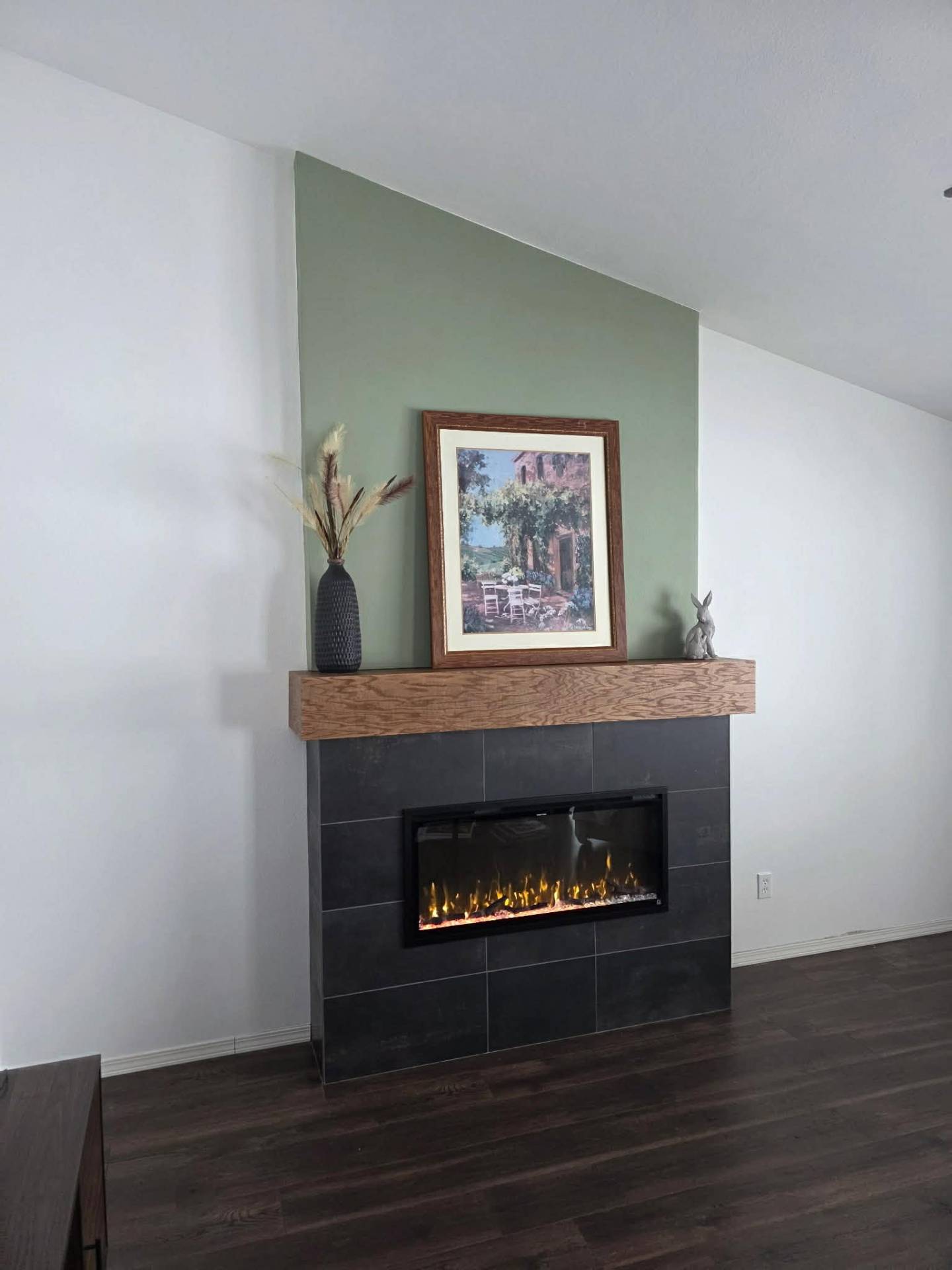 Manson WA fireplace upgrade with sage green accent panel, oak mantle, and recessed linear fireplace