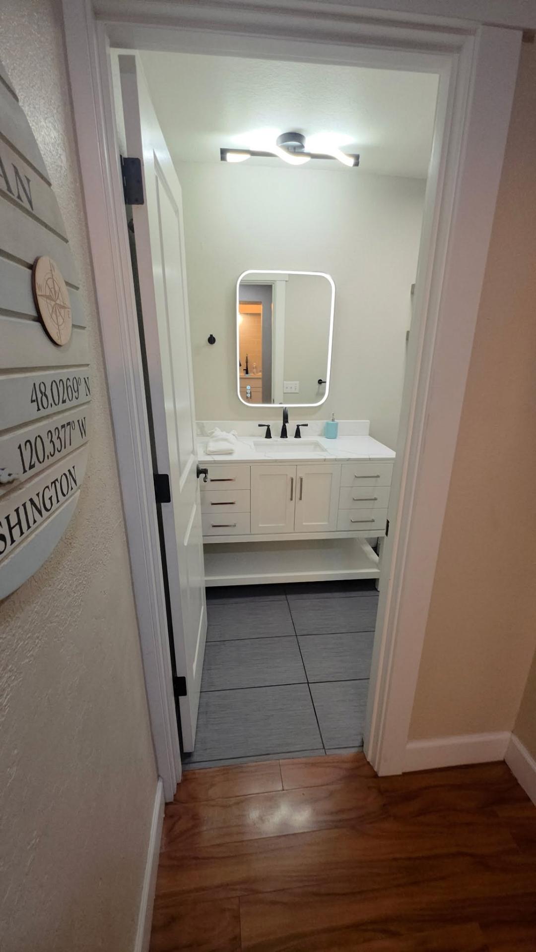 Entry view of remodeled Lake Chelan bathroom with new vanity and lighting