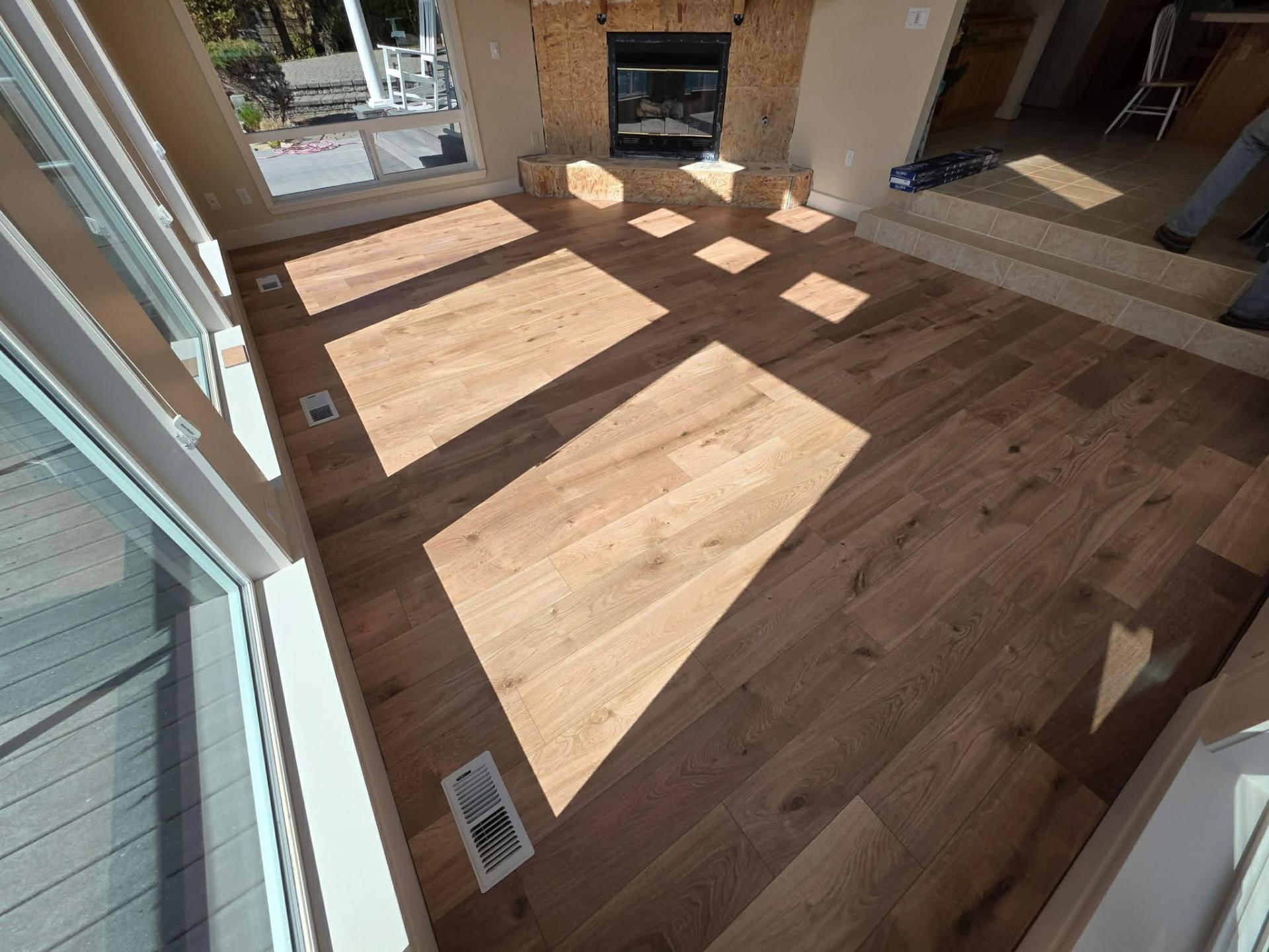 Luxury vinyl plank flooring meeting existing tile in Lake Chelan lake home