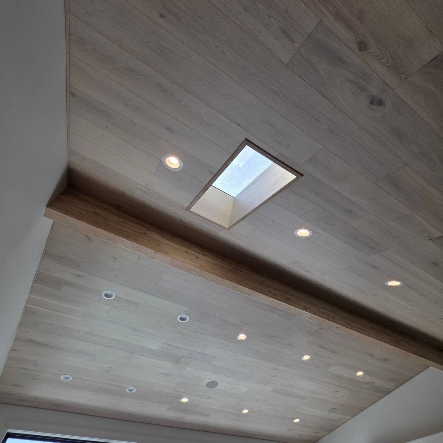 White oak plank ceiling with recessed skylight well and can lighting in Manson WA